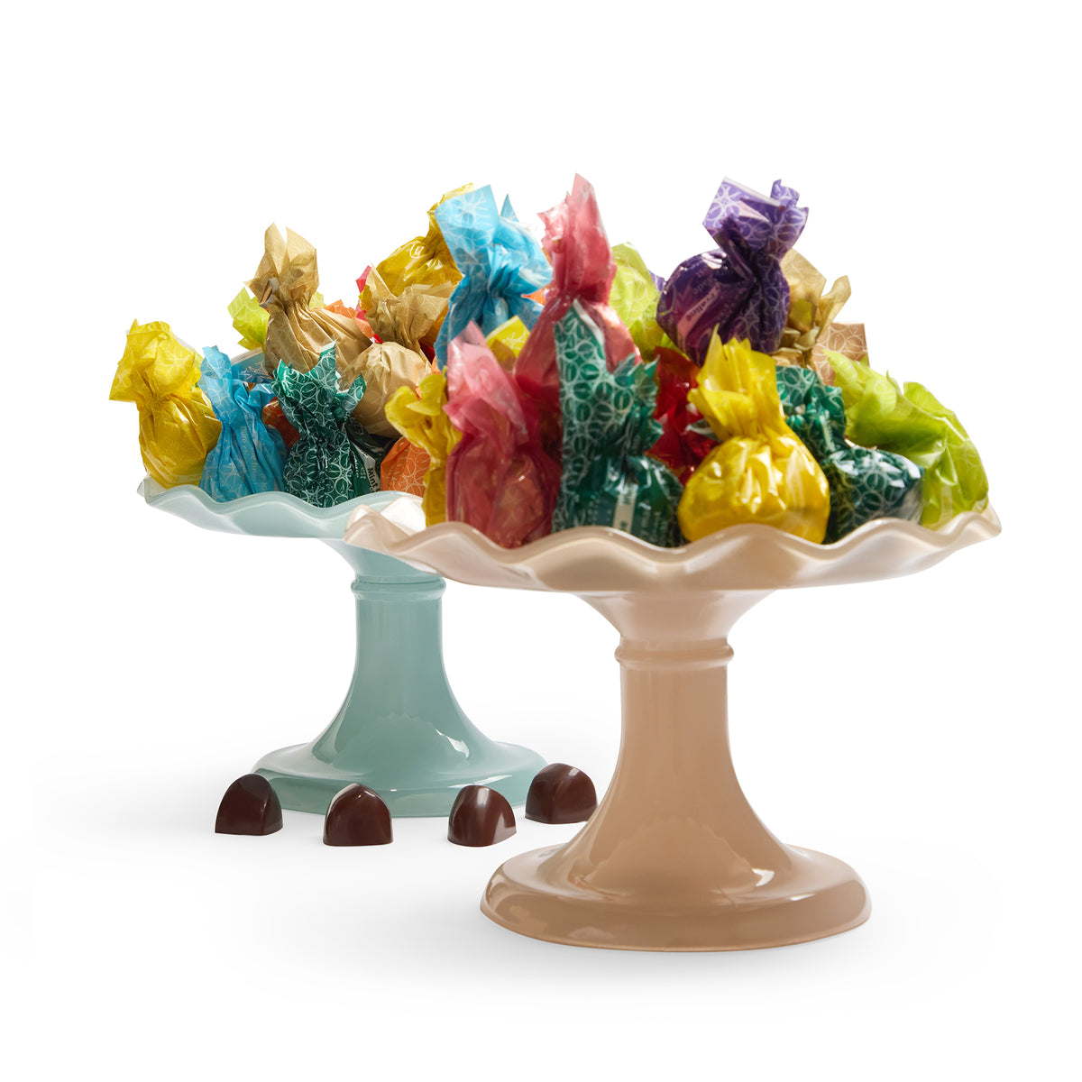 Fardoulis assorted chocolates in colourful cellophane wrappers on two pedestal stands, with four unwrapped chocolates in front.