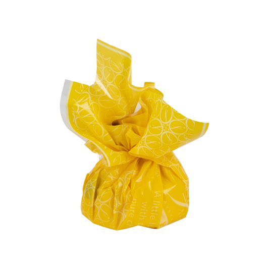 “Fardoulis hazelnut praline chocolate in a bright yellow cellophane wrapper with a white circular pattern.”