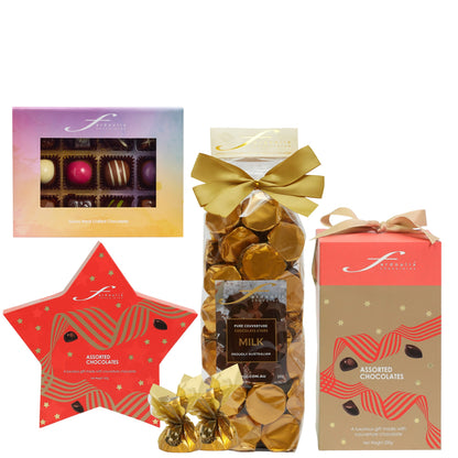 Fardoulis Christmas chocolate selection with a Rainbow gourmet box, gold-bowed milk chocolate stars bag, tall reindeer box and red star-shaped gift box.