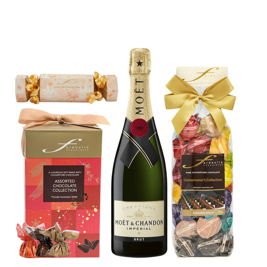 “Moët & Chandon Champagne with a Fardoulis red Christmas chocolate box, gold-bowed Connoisseurs Collection gift bag and milk chocolate stars bonbon.”