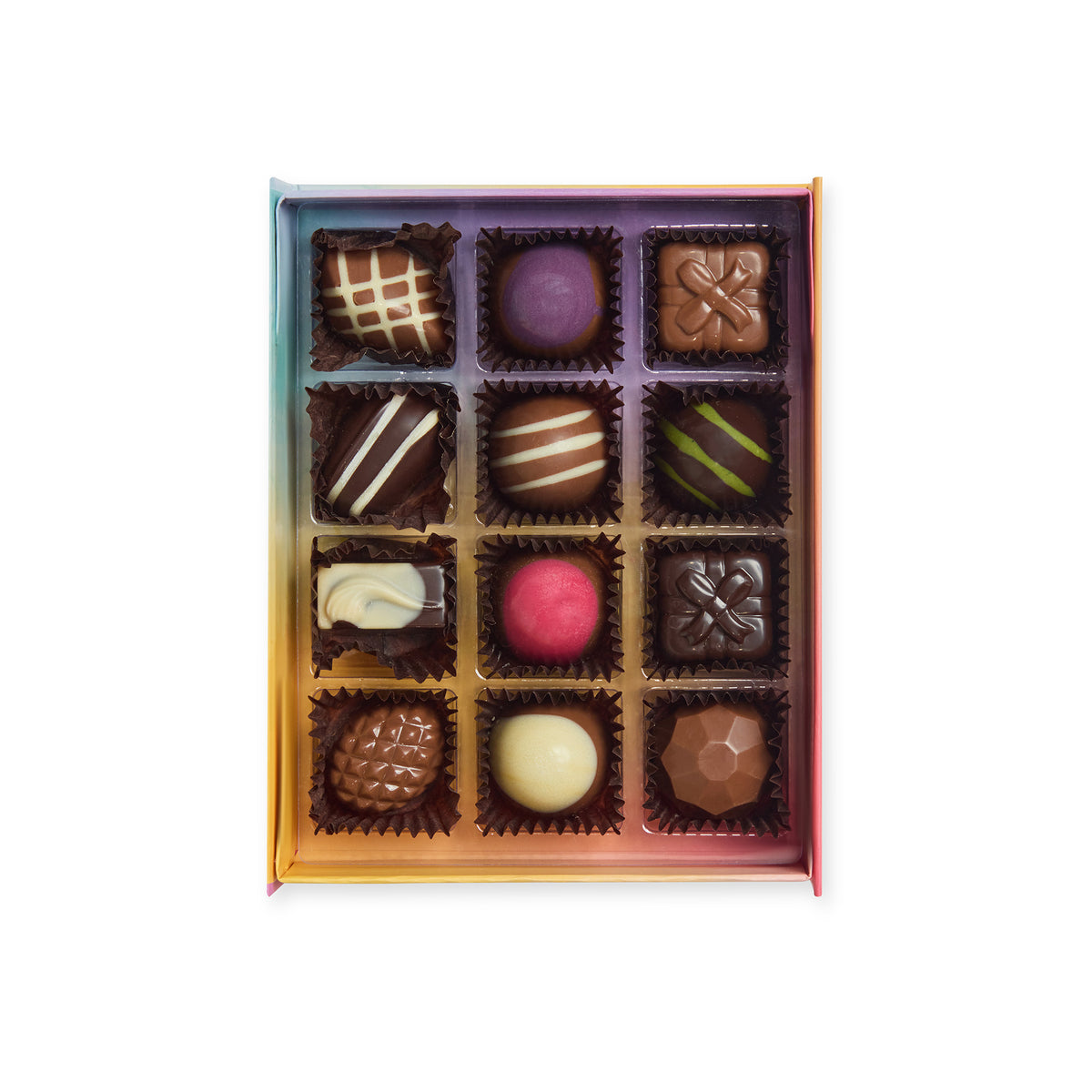 “Open rainbow chocolate box containing 12 assorted decorated chocolates arranged in four rows of three.”