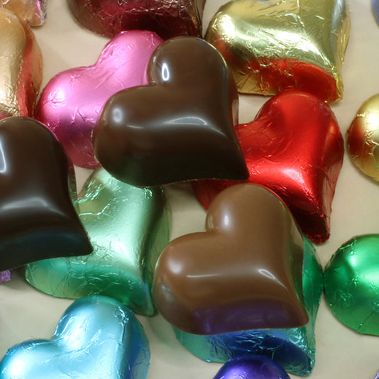 Shop colorful foiled chocolate hearts by the kilo in assorted colours  milk or dark chocolate, made from pure couverture chocolate. Perfect for, corporate gifts, favours and gifts. Clients, reception desks for customers.
