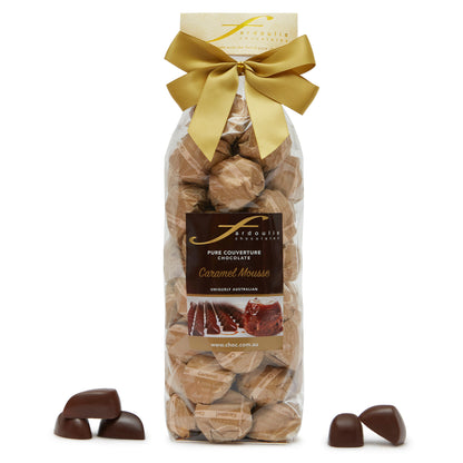 Smooth and sweet caramel mousse filled epicurean chocolates in a gift bag — made with pure couverture chocolate. A delightful gift from Fardoulis Chocolates.