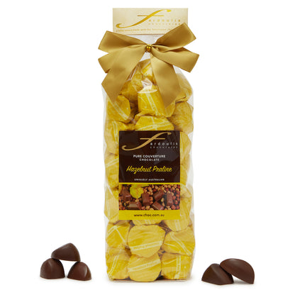 Rich hazelnut praline filled epicurean chocolates in a gift bag — made with pure couverture chocolate. A nutty indulgence from Fardoulis Chocolates.