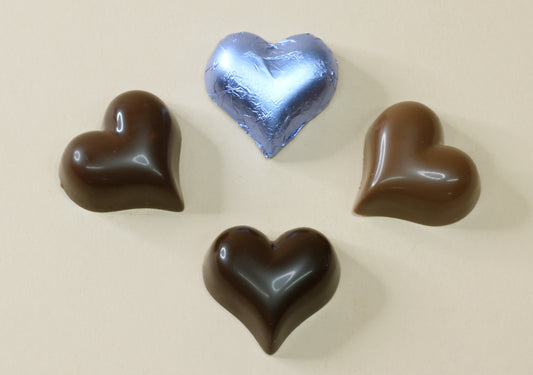 Shop by baby  blue foil heart chocolates bamade with pure couverture chocolate. Choose solid milk or solid dark chocolate for wedding favours, gifts and special events.