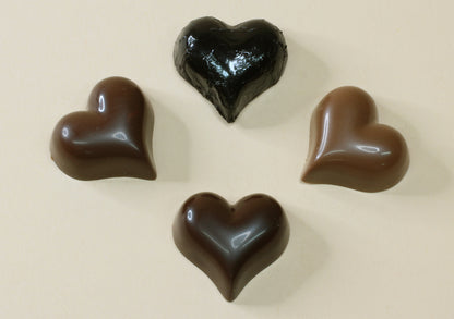 Shop black foiled chocolate hearts by the unit in raspberry truffle, milk or dark chocolate, made from pure couverture chocolate. Perfect for favours and gifts.