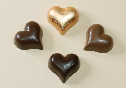 Shop bronze foiled chocolate hearts in orange truffle, milk or dark chocolate, made from pure couverture chocolate. Perfect for favours and gifts.
